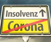 Corona und Insolvenz steht auf einem Straßenschild