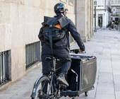 courier-man-riding-cargo-bike-along-city-his-way-deliver-package